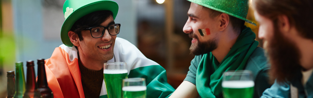 Guys drinking beer and talking on St Patrick day